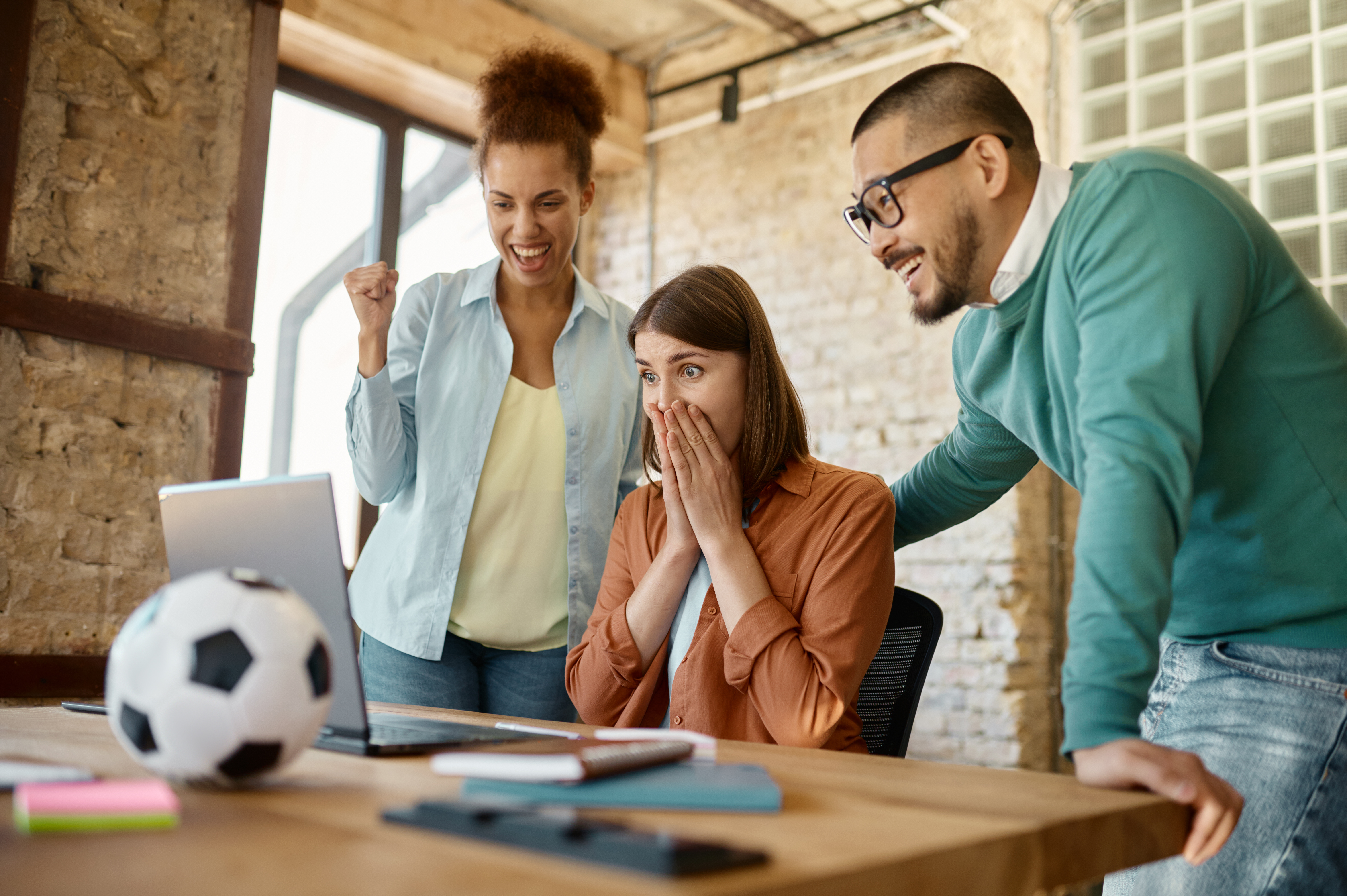 Excited young coworkers rejoicing getting good news congratulating success